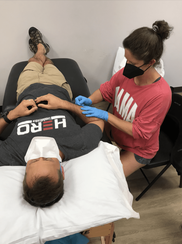 Dry needling student practicing technique with another student 